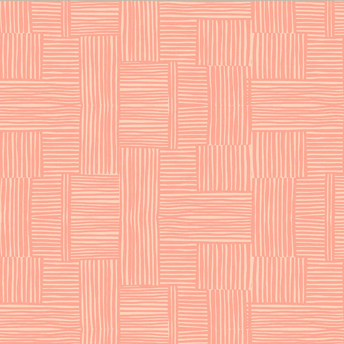 Patterned fabric with a geometric design on a pink background, featuring a ruler at the bottom for scale.